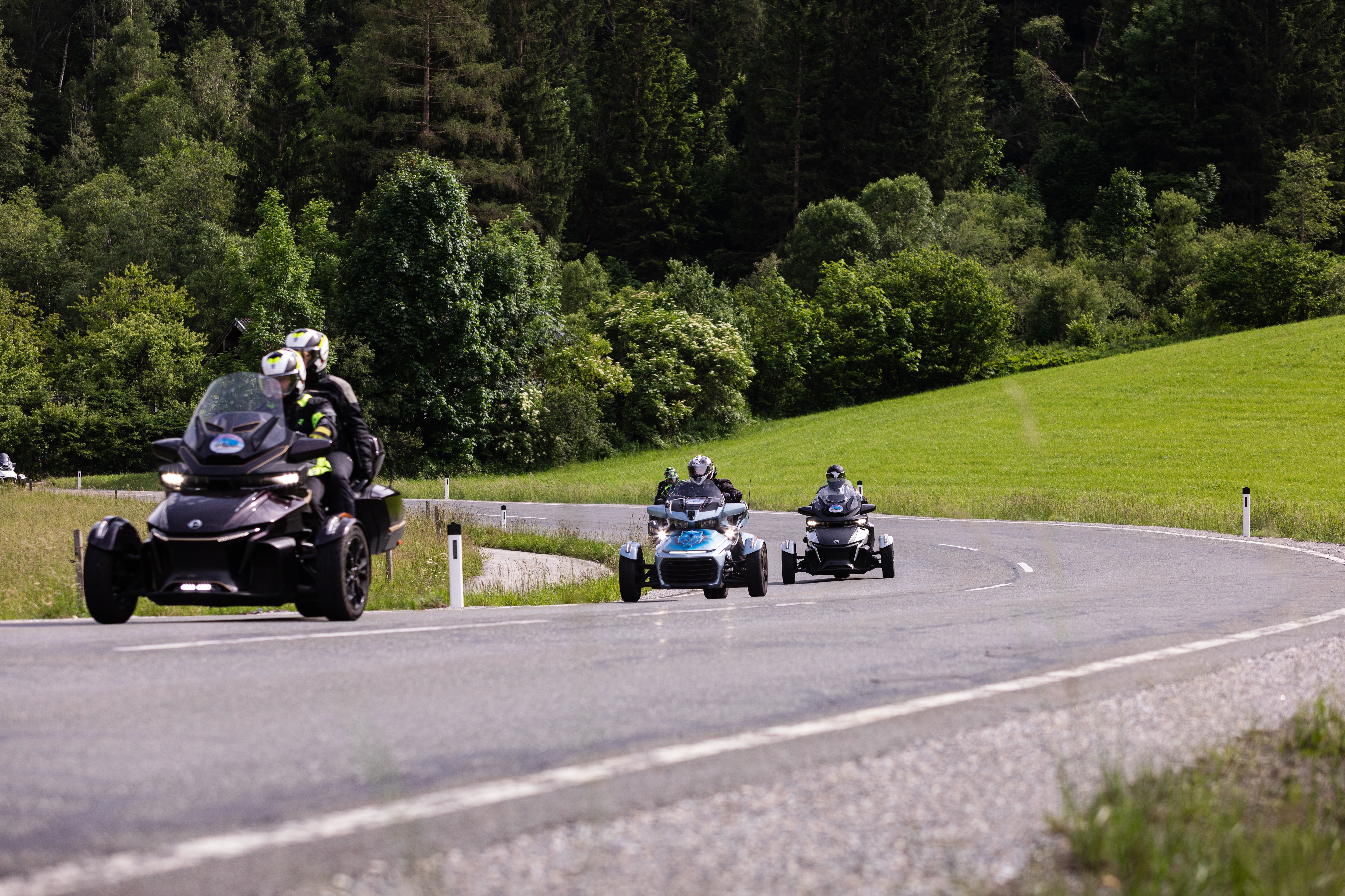 2 Spyder RTs and a Spyder F3 Limited on a countryside road.